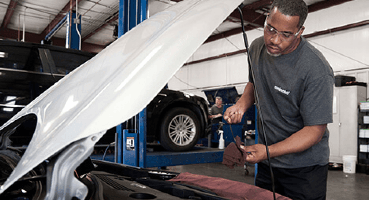 A Meineke technician working on a vehicle