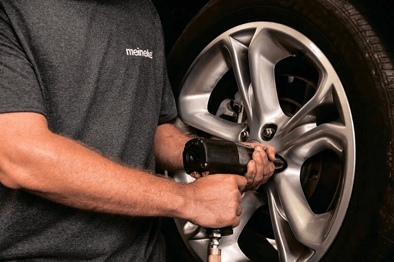 Tire Rotation services being provided at a Meineke auto repair shop